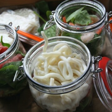Mason jar noodle pots with hinged lids.
