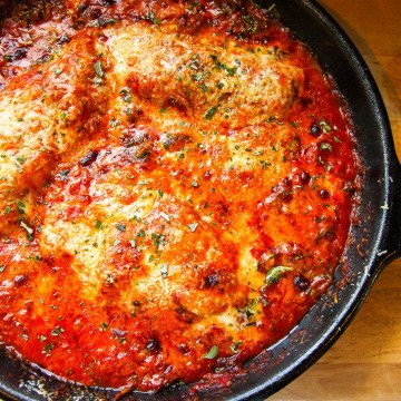 A pan of baked chicken on a table