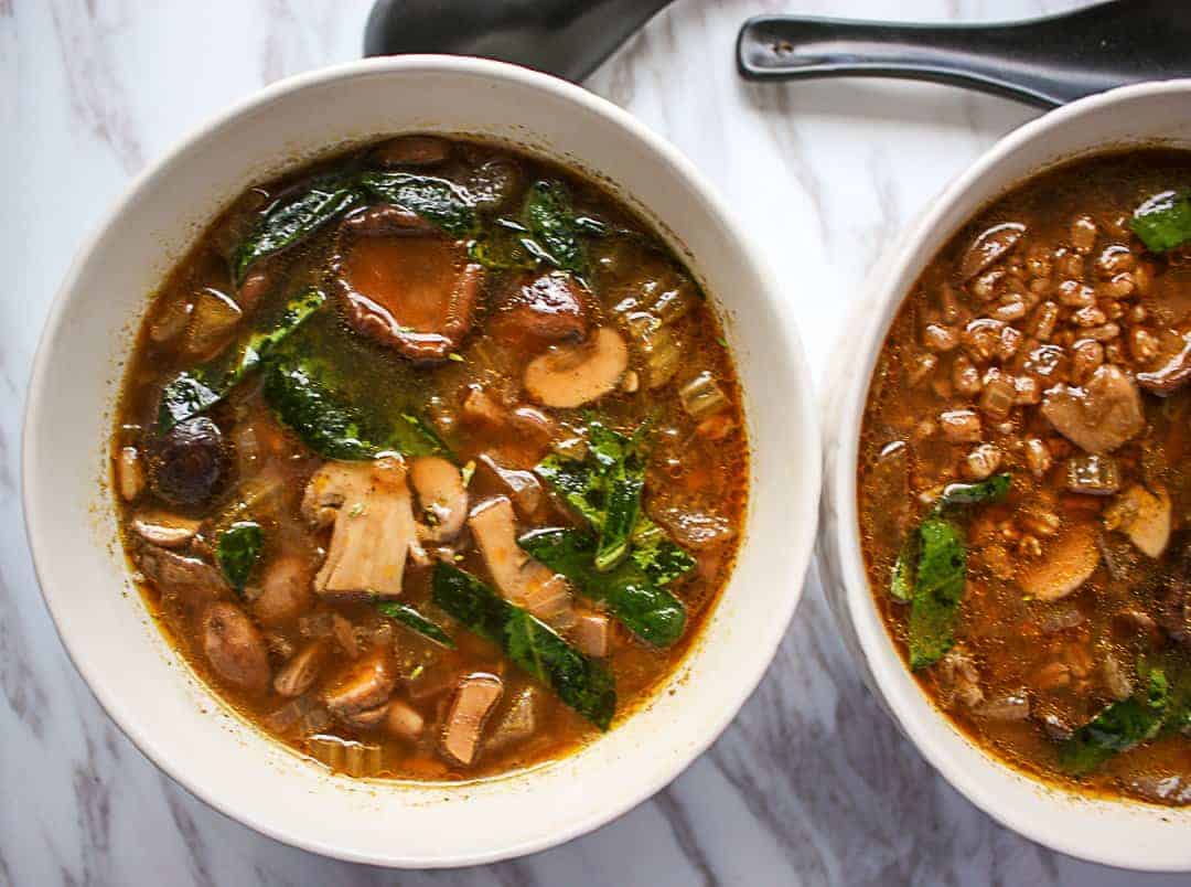 A bowl of soup with mushrooms