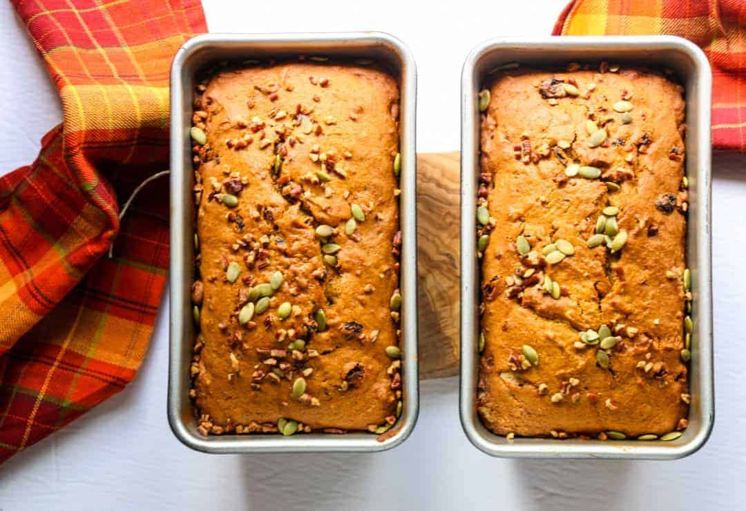 Two baked pumpkin spice loaves in breadpans