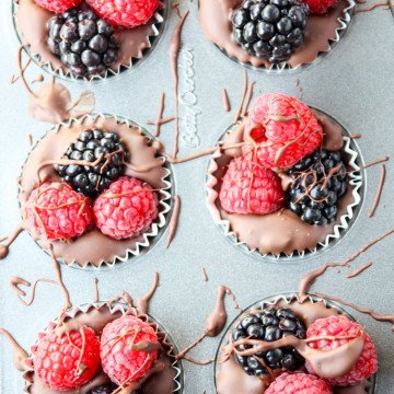 Chocolate cups with raspberries and blackberries in a mini muffin pan