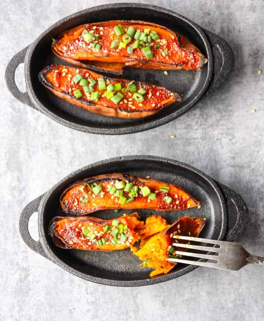 Two pans of food on a table with a fork