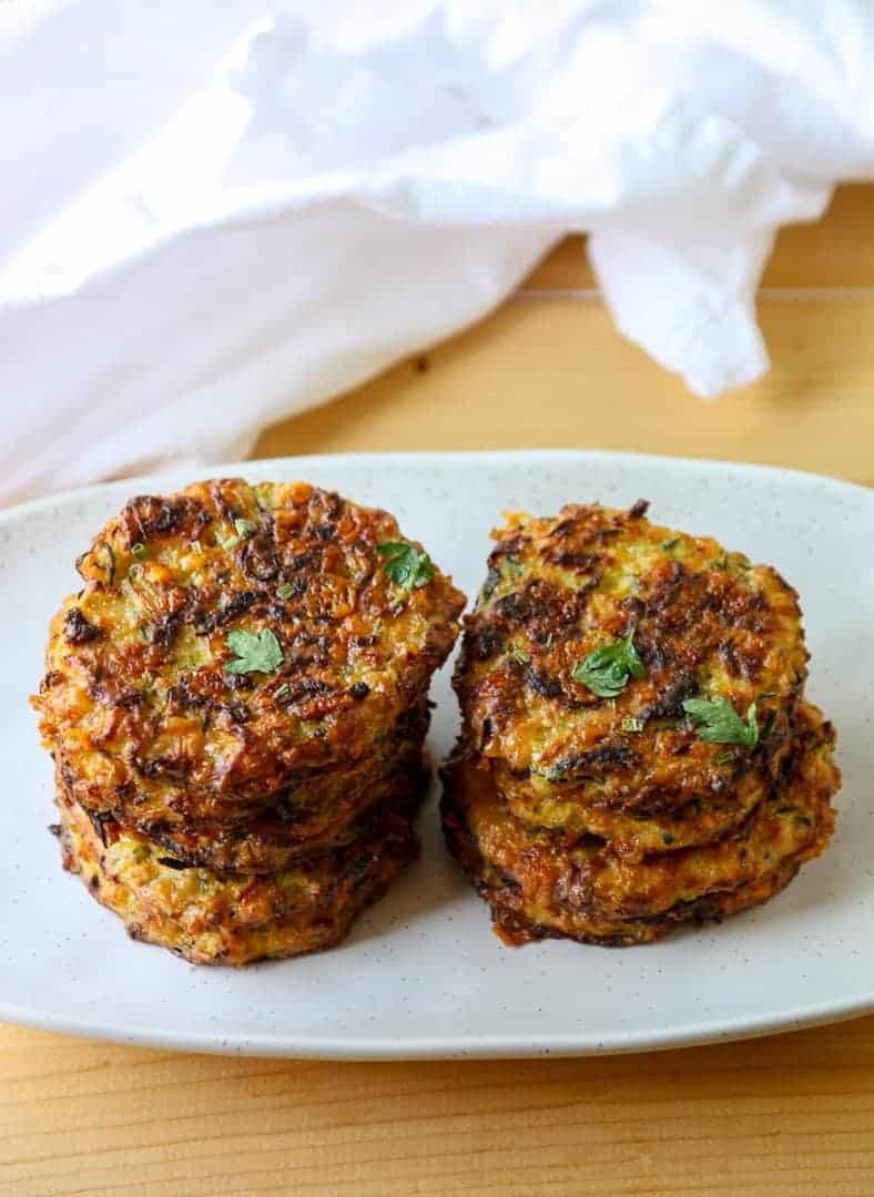 A plate of food on a table, with Fritters 