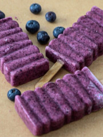 Blueberry popsicles on parchment paper.
